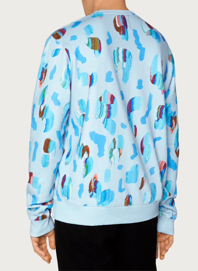 Male model wearing wearable art sweatshirt. Blue hoodie with artsy design made from organic cotton. Back picture.