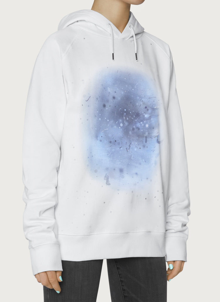 Female model with white sweatshirts on. The hoodie has blue, artistic design. Wearable art, unisex hoodie for him and her. Front picture.