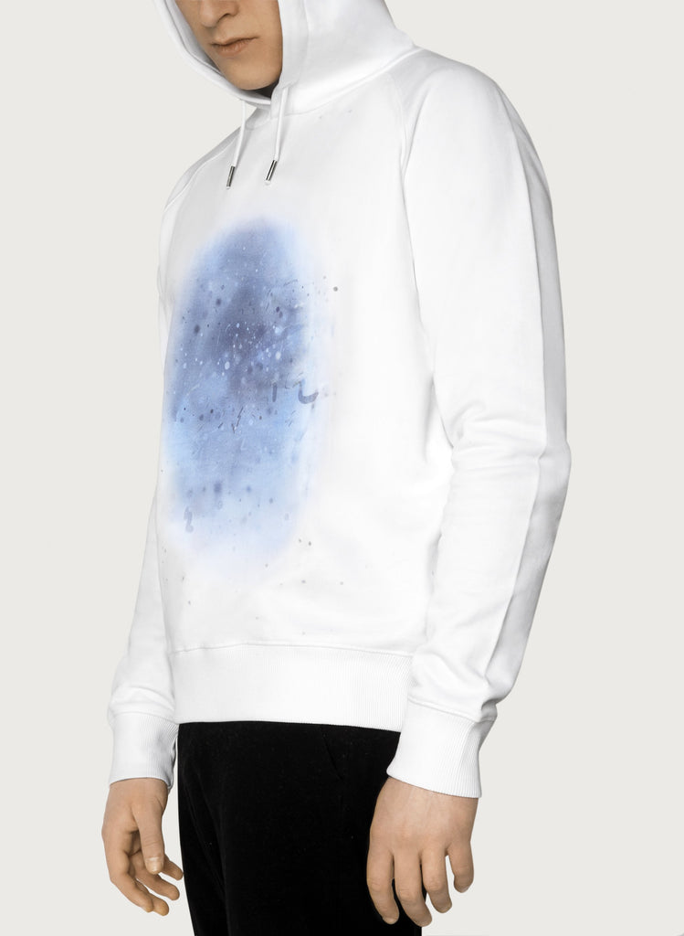 Male model wearing white sweatshirts with blue, artistic design. Wearable art, unisex hoodie for him and her. Front picture.