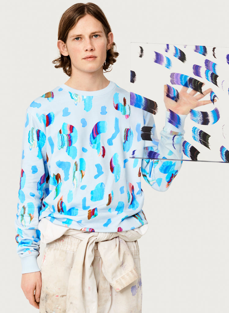 Male model wearing wearable art sweatshirt. Blue hoodie with artsy design made from organic cotton. Artistic version.