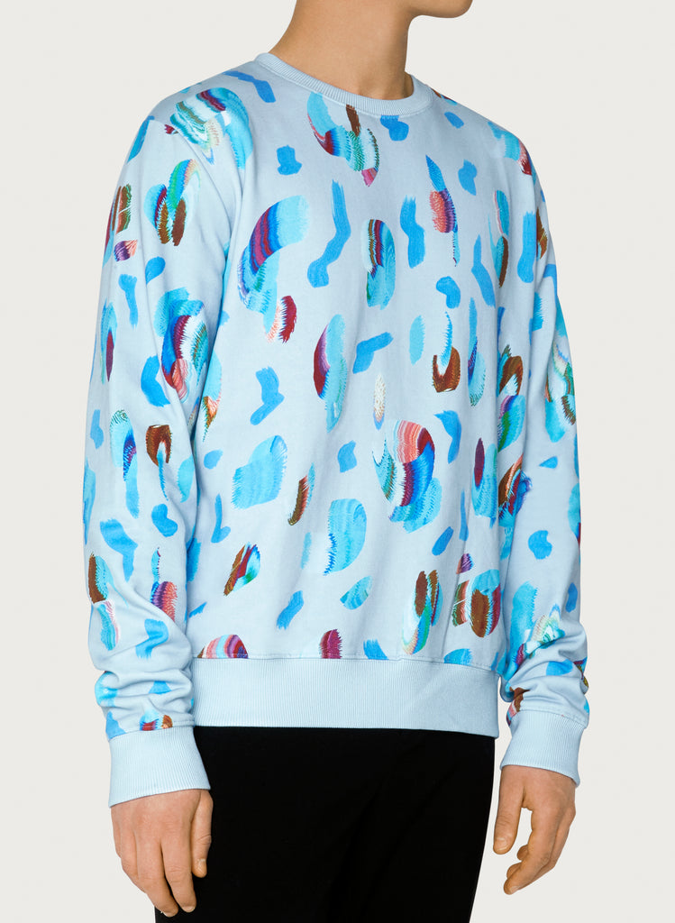 Male model wearing wearable art sweatshirt. Blue hoodie with artsy design made from organic cotton. Front picture.