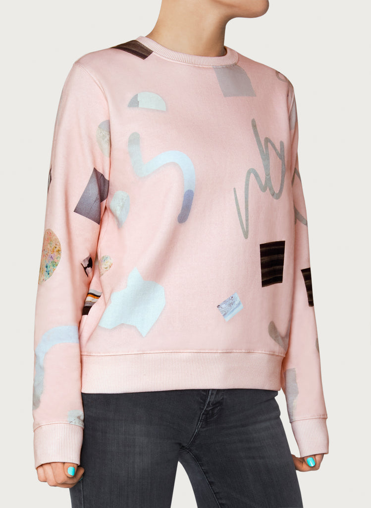 Woman with wearable art sweatshirt on. Pink-coloured hoodie, minimalistic design, made from sustainable material. Front picture.
