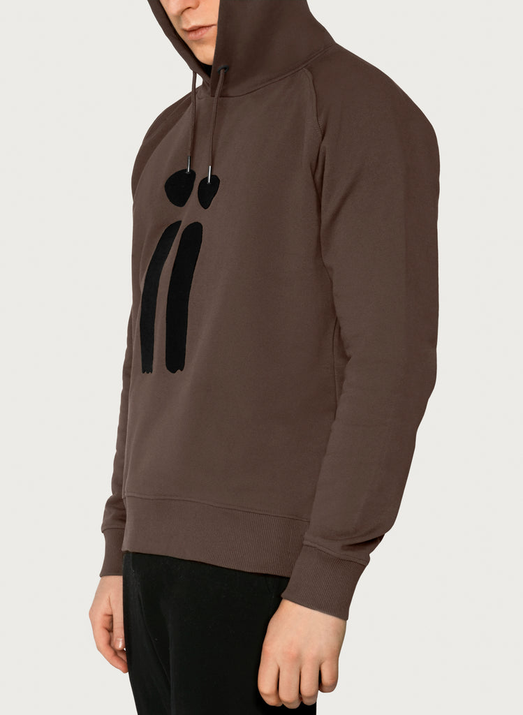 Male model presenting brown, unisex sweatshirt with ARTiiG logo on. Wearable art hoodie for him and her. Front picture.