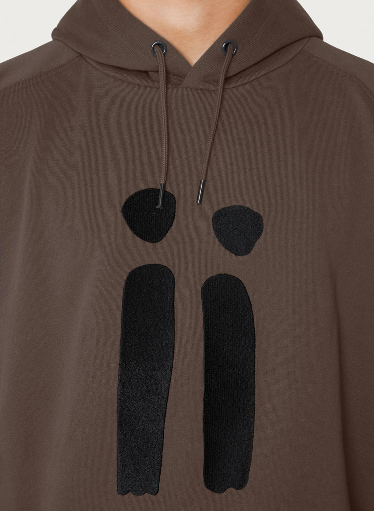 Zoomed in brown, unisex sweatshirt with ARTiiG logo on. Wearable art hoodie for him and her. Male version.